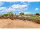 Wide open backyard features desert landscaping, a wooden bridge, and mini golf at 13729 E Rancho Laredo Dr, Scottsdale, AZ 85262