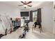 Bedroom featuring a ceiling fan, large window, tile floors and room for storage at 13729 E Rancho Laredo Dr, Scottsdale, AZ 85262