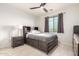 Relaxing bedroom featuring a modern bed frame, wood look floors, and stylish bedside lamps at 13729 E Rancho Laredo Dr, Scottsdale, AZ 85262