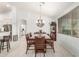 Bright dining room with wood table, leather chairs, and decorative chandelier at 13729 E Rancho Laredo Dr, Scottsdale, AZ 85262