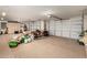 Large garage with overhead doors, built-in cabinets, and epoxy flooring is used for storage at 13729 E Rancho Laredo Dr, Scottsdale, AZ 85262