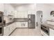 Bright kitchen featuring white cabinetry, granite counters, and stainless steel appliances at 13729 E Rancho Laredo Dr, Scottsdale, AZ 85262