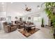 Spacious living room featuring tile floors, a stone fireplace, and ample seating at 13729 E Rancho Laredo Dr, Scottsdale, AZ 85262