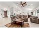 Open-concept living room with tile floors, comfortable seating, and views of the kitchen and dining area at 13729 E Rancho Laredo Dr, Scottsdale, AZ 85262