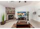 Bright and airy living room features tile flooring and a cozy stone fireplace at 13729 E Rancho Laredo Dr, Scottsdale, AZ 85262