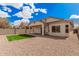 Home's exterior showcases a covered patio and low-maintenance desert landscaping in the backyard at 1434 W Brangus Way, San Tan Valley, AZ 85143