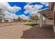 Spacious backyard featuring low-maintenance landscaping with decorative gravel and small grass area at 1434 W Brangus Way, San Tan Valley, AZ 85143