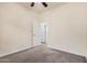 Carpeted bedroom features a ceiling fan and a doorway to another room at 1434 W Brangus Way, San Tan Valley, AZ 85143