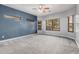 A bedroom featuring neutral walls, a ceiling fan, and several windows for ample natural light at 1434 W Brangus Way, San Tan Valley, AZ 85143