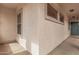 Covered entry with window details in a home's stucco facade at 1434 W Brangus Way, San Tan Valley, AZ 85143