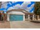 Stylish single-story home boasts a blue garage door, covered entry, and low-maintenance landscaping at 1434 W Brangus Way, San Tan Valley, AZ 85143