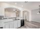 An open-concept kitchen featuring white cabinets and a stainless steel sink at 1434 W Brangus Way, San Tan Valley, AZ 85143