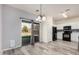 Kitchen with white cabinets, black appliances, gray backsplash, and wood-style floors at 1434 W Brangus Way, San Tan Valley, AZ 85143