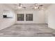 Inviting living room with hardwood floors, ceiling fans, and an open view of the kitchen at 1434 W Brangus Way, San Tan Valley, AZ 85143