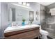 Modern bathroom featuring double sinks, sleek wood vanity, and glass enclosed shower at 14402 N Silverado Dr, Fountain Hills, AZ 85268