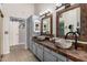 Bathroom featuring dual sinks, stone countertops, and decorative mirrors at 14402 N Silverado Dr, Fountain Hills, AZ 85268