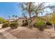 Inviting home with desert landscaping and mature trees creating a serene setting at 14402 N Silverado Dr, Fountain Hills, AZ 85268