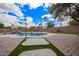 The backyard features a luxurious pool, lush greenery, and a charming pergola for outdoor enjoyment at 14609 W Marcus Dr, Surprise, AZ 85374