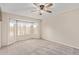 Bright bedroom with a ceiling fan, soft carpet, and a large bay window at 14609 W Marcus Dr, Surprise, AZ 85374