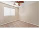 Neutral bedroom featuring a window for natural light, carpet flooring and ceiling fan at 14609 W Marcus Dr, Surprise, AZ 85374