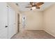 Carpeted bedroom highlighting a ceiling fan and access to other rooms through white paneled doors at 14609 W Marcus Dr, Surprise, AZ 85374