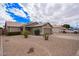 Single-story home with desert landscaping, a two-car garage, paved driveway, and neutral paint at 14609 W Marcus Dr, Surprise, AZ 85374