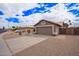 Single-story home with desert landscaping, a two-car garage, paved driveway, and neutral paint at 14609 W Marcus Dr, Surprise, AZ 85374