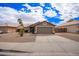 Traditional single-story home with a two-car garage, desert landscaping, and a paved driveway at 14609 W Marcus Dr, Surprise, AZ 85374