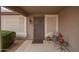 Front porch with security door, neutral color scheme, potted plants, and seating arrangement at 14609 W Marcus Dr, Surprise, AZ 85374