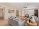 Comfortable living room with neutral tones, tile floors, ceiling fan, and cozy furniture at 14609 W Marcus Dr, Surprise, AZ 85374