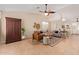 Open living room with neutral tones, ceiling fan, wood accents, and view to kitchen bar at 14609 W Marcus Dr, Surprise, AZ 85374