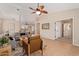 Open living room with tile flooring, neutral paint, ceiling fan, and a cozy seating area at 14609 W Marcus Dr, Surprise, AZ 85374