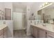 Bathroom featuring double sinks, soft decor, and a shower with sliding glass doors at 15050 N Thompson Peak Pkwy # 1006, Scottsdale, AZ 85260