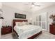 This bedroom has a warm wood headboard, soft textures, and a ceiling fan at 15050 N Thompson Peak Pkwy # 1006, Scottsdale, AZ 85260