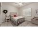 Comfortable bedroom with decor, ceiling fan, and shuttered window at 15050 N Thompson Peak Pkwy # 1006, Scottsdale, AZ 85260