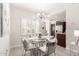 Bright dining area with a modern chandelier, glass table, and seating for four at 15050 N Thompson Peak Pkwy # 1006, Scottsdale, AZ 85260