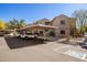 Exterior of a multi-Gathering home with assigned covered parking spots and well-kept landscaping at 15050 N Thompson Peak Pkwy # 1006, Scottsdale, AZ 85260