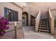 Inviting condo entrance featuring a welcoming front door and easy access to upper-level units via stairs at 15050 N Thompson Peak Pkwy # 1006, Scottsdale, AZ 85260