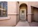 Close up of front door in neutral tones, with a decorative wreath and a welcoming entrance at 15050 N Thompson Peak Pkwy # 1006, Scottsdale, AZ 85260