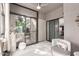 Relaxing sunroom with tiled floors, wicker chairs, bright sliding glass doors, and decorative stone pillar at 15050 N Thompson Peak Pkwy # 1006, Scottsdale, AZ 85260