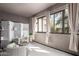 Relaxing sunroom with neutral tones, wicker chairs, bright windows, decorative curtains, and textured walls at 15050 N Thompson Peak Pkwy # 1006, Scottsdale, AZ 85260