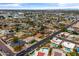 A captivating aerial view captures a neighborhood with lush landscaping, community pools, and nearby roads at 1509 W Tuckey Ln, Phoenix, AZ 85015