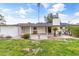 Backyard view featuring a lawn, covered patio, and lush landscaping at 1509 W Tuckey Ln, Phoenix, AZ 85015