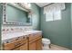 Bathroom with decorative mirror and a vanity with tile countertop at 1509 W Tuckey Ln, Phoenix, AZ 85015