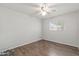 A bright bedroom featuring hardwood flooring, a ceiling fan, and a window with blinds at 1509 W Tuckey Ln, Phoenix, AZ 85015