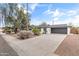 Single-story home with an attached garage and a well-manicured front yard under a blue sky at 1509 W Tuckey Ln, Phoenix, AZ 85015