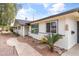 Single-story home featuring lush desert landscaping, flagstone path, and well-maintained exterior at 1509 W Tuckey Ln, Phoenix, AZ 85015