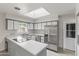 Bright kitchen features stainless steel appliances, gray and white cabinets, and a skylight at 1509 W Tuckey Ln, Phoenix, AZ 85015