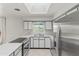 Bright kitchen features stainless steel appliances, gray and white cabinets, and a skylight at 1509 W Tuckey Ln, Phoenix, AZ 85015