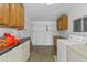 Functional laundry room has a washer, dryer, cabinets, and ample storage space at 1509 W Tuckey Ln, Phoenix, AZ 85015